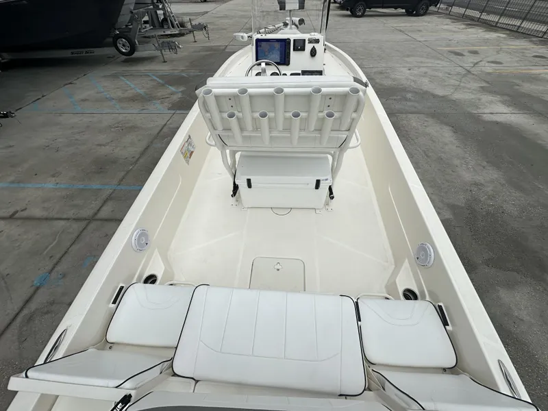 Slide: The Image of 2023 Skeeter SX230 boat interior with white seating and control panel. - 14