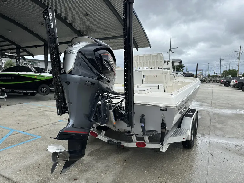 Slide: The Image of 2023 Skeeter SX230 boat with Yamaha engine on trailer, parked outdoors. - 20