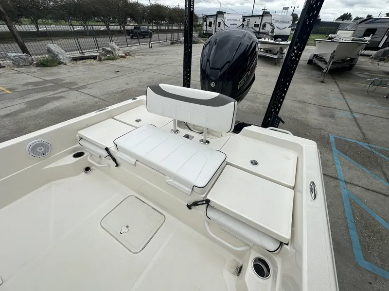 Slide: The Image of 2023 Skeeter SX230 boat with seating and motor, parked in a lot. - 23