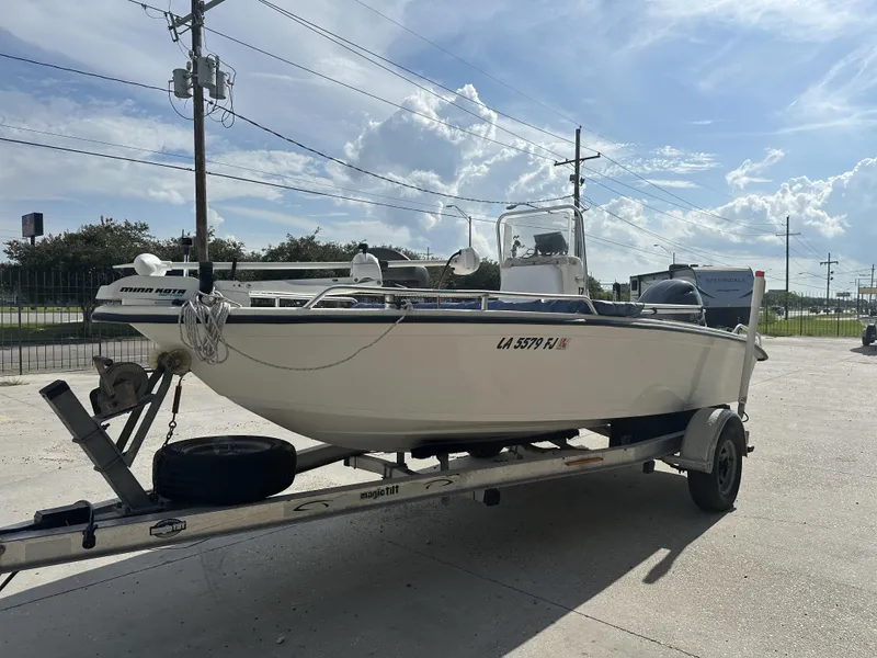 Slide: The Image of 2004 Sea Chaser 175 CC boat on trailer, parked outdoors under a clear sky. - 10