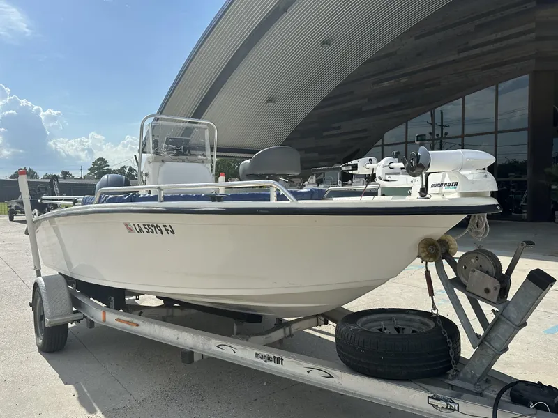 Slide: The Image of 2004 Sea Chaser 175 CC boat on trailer, parked outdoors under a curved roof. - 5