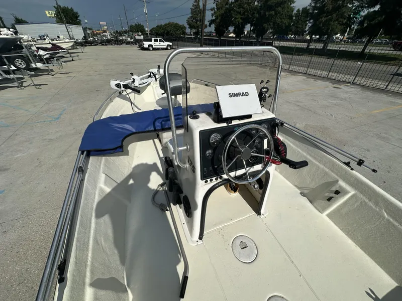 Slide: The Image of 2004 Sea Chaser 175 CC boat interior with steering wheel and Simrad navigation system. - 8