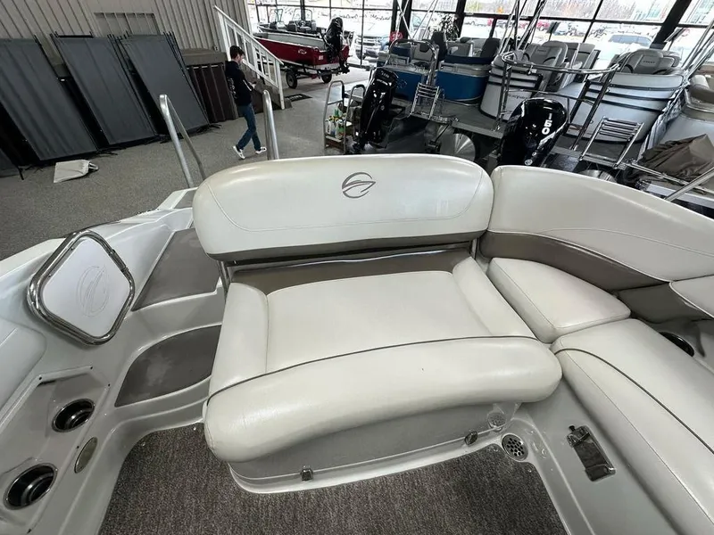 Slide: The Image of 2012 Crownline E1 boat interior with white seating in showroom. - 14