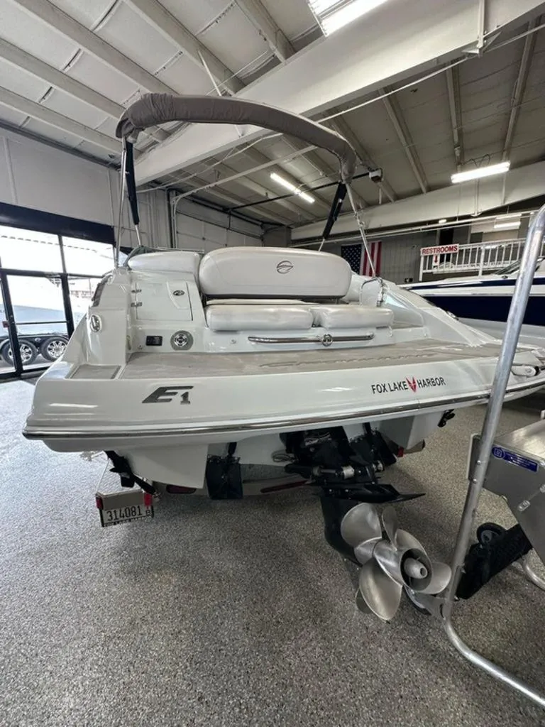 Slide: The Image of 2012 Crownline E1 boat in showroom, rear view with propeller and canopy. - 17