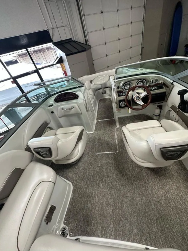 Slide: The Image of Interior of a 2012 Crownline E1 boat with white seating and modern dashboard. - 3