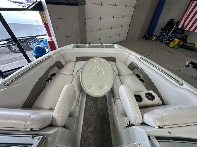 Slide: The Image of 2012 Crownline E1 boat interior with white seating and central table. - 4