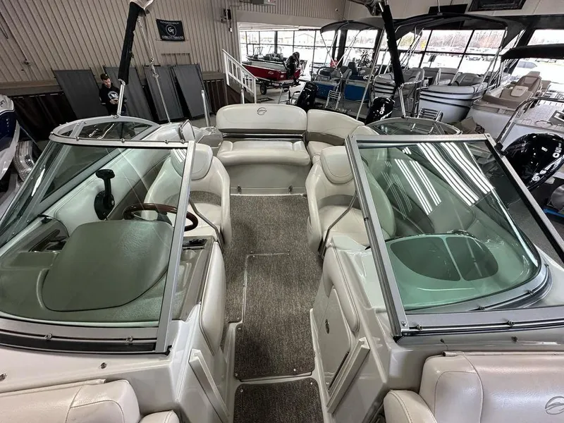 Slide: The Image of 2012 Crownline E1 boat interior with seating and windshield in showroom. - 8