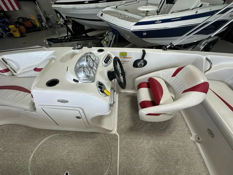 Slide: The Image of Interior of a 2011 Starcraft 2000 boat with red and white seating. - 10