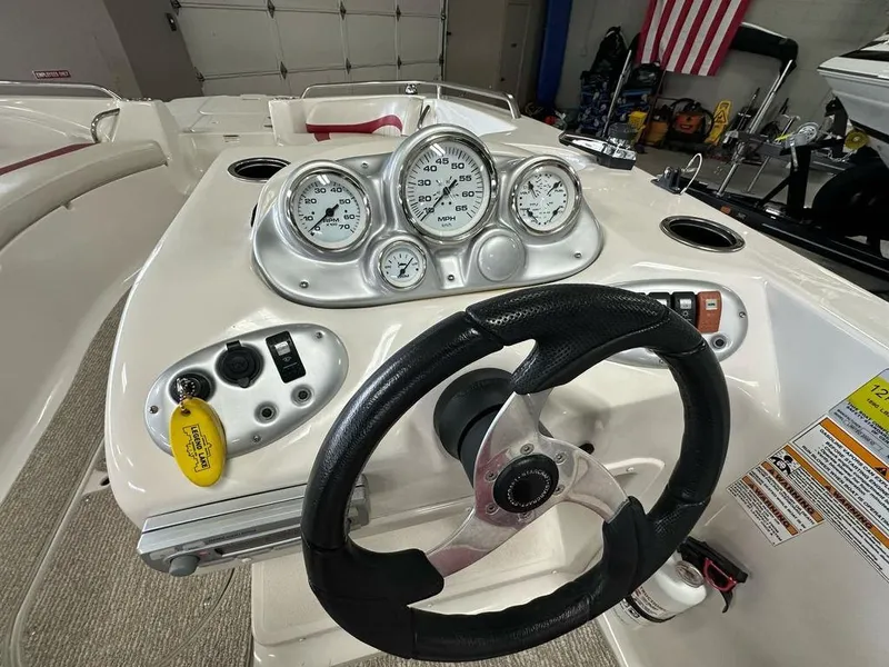 Slide: The Image of Steering console of a 2011 Starcraft 2000 boat with gauges and controls. - 11