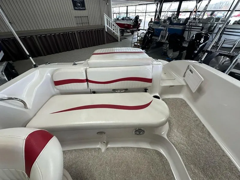 Slide: The Image of Interior of a 2011 Starcraft 2000 boat with white and red seating. - 13