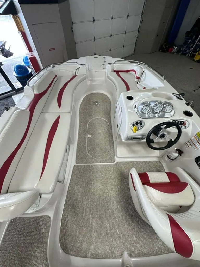 Slide: The Image of Interior of a 2011 Starcraft 2000 boat with red and white seating. - 3