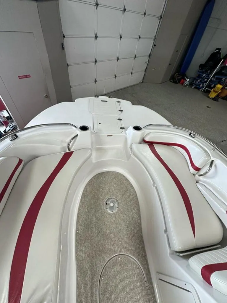 Slide: The Image of Interior of a 2011 Starcraft 2000 boat with red and white seating. - 4