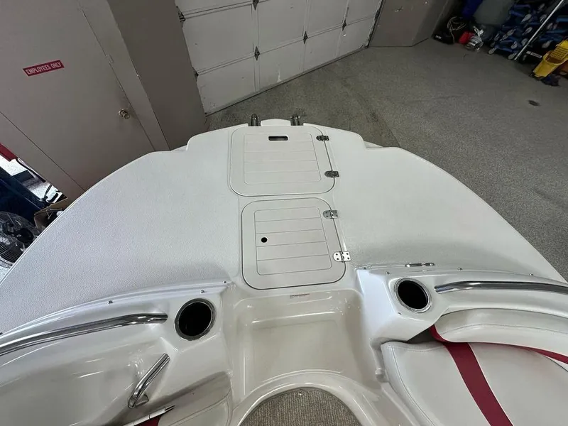 Slide: The Image of 2011 Starcraft 2000 boat interior with storage compartments and seating in a garage. - 6