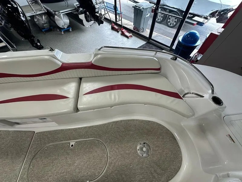 Slide: The Image of Interior of a 2011 Starcraft 2000 boat with white and red seating. - 7
