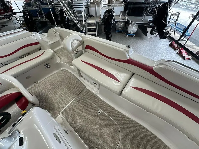 Slide: The Image of Interior of a 2011 Starcraft 2000 boat with white and red seating. - 8