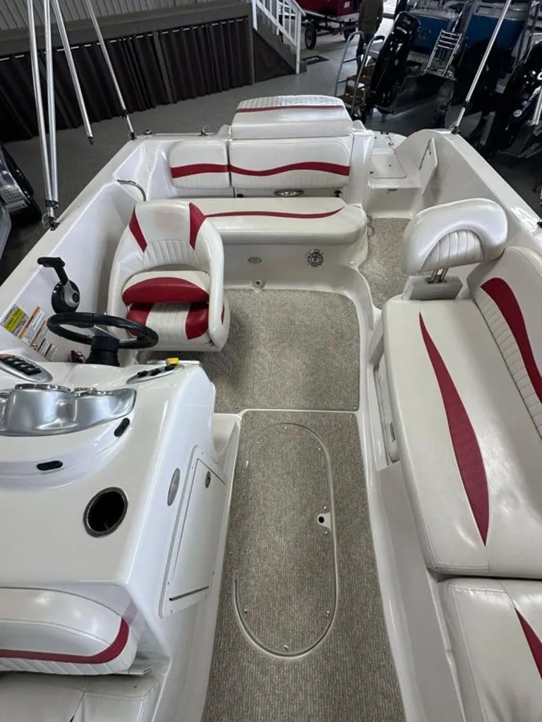 Slide: The Image of Interior of a 2011 Starcraft 2000 boat with white and red seating. - 9