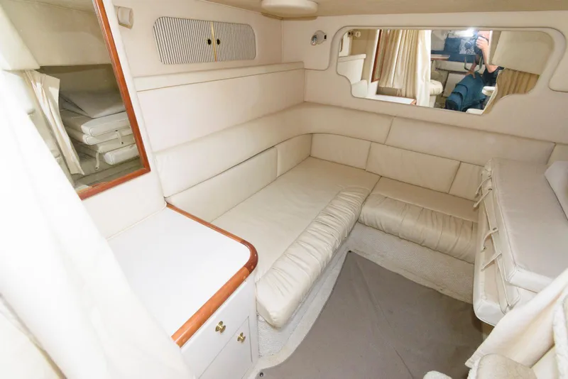 Slide: The Image of Interior of 2001 Sea Ray 340 Sundancer with cream upholstery and wood accents. - 12