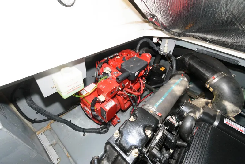 Slide: The Image of Engine compartment of a 2001 Sea Ray 340 Sundancer boat, featuring a red engine. - 15