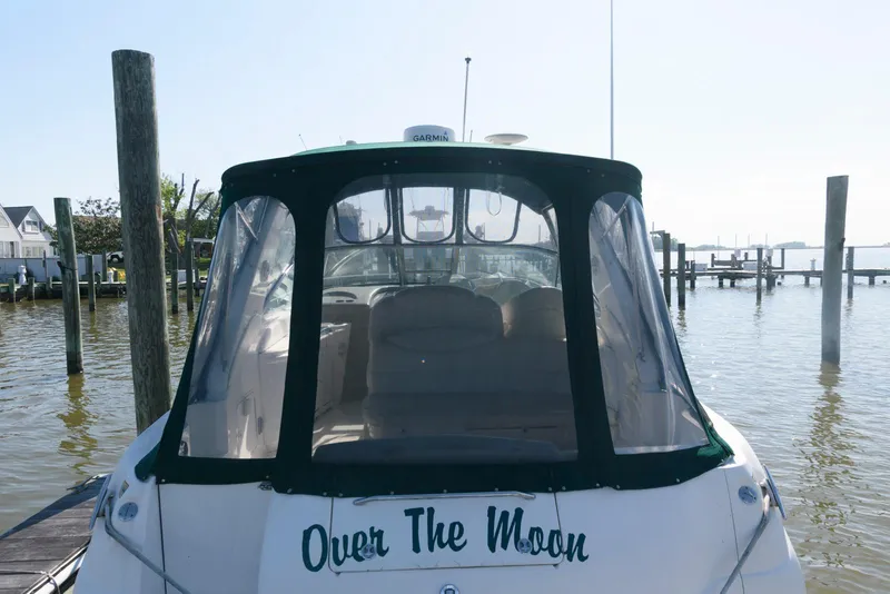 Slide: The Image of 2001 Sea Ray 340 Sundancer boat named "Over The Moon" docked at a marina. - 2