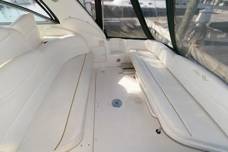 Slide: The Image of 2001 Sea Ray 340 Sundancer interior with white seating and clear windows. - 4