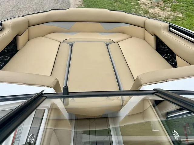 Slide: The Image of 2019 Moomba Makai™ boat interior with beige seating and sleek design. - 11