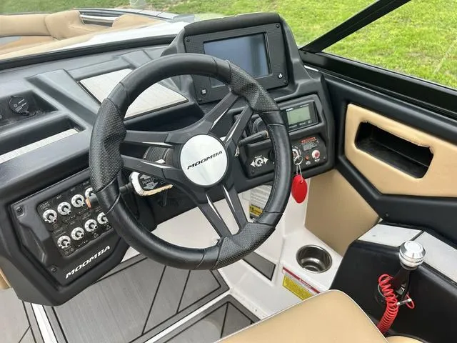 Slide: The Image of 2019 Moomba Makai™ boat dashboard with steering wheel and control panel. - 13