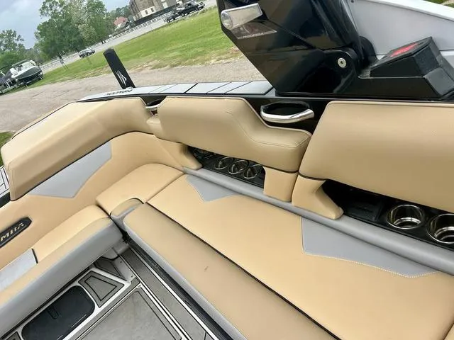 Slide: The Image of 2019 Moomba Makai™ boat interior with beige seating and cup holders. - 15