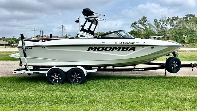 Slide: The Image of 2019 Moomba Makai™ boat on trailer, parked on grass, under cloudy sky. - 4