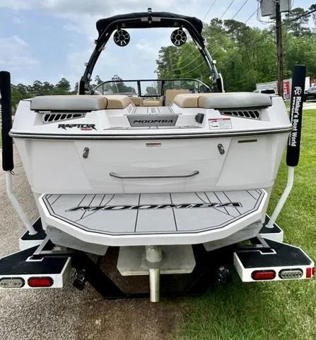 Slide: The Image of 2019 Moomba Makai™ boat rear view with Raptor engine, on a trailer, parked outdoors. - 6