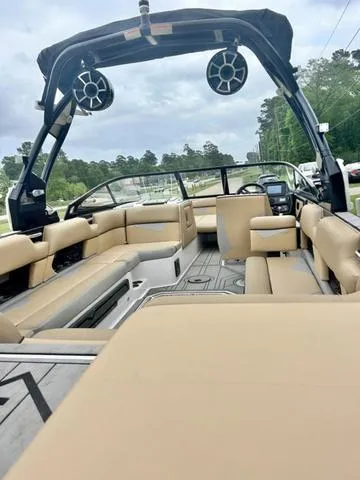 Slide: The Image of 2019 Moomba Makai™ boat interior with beige seating and wakeboard tower speakers. - 9