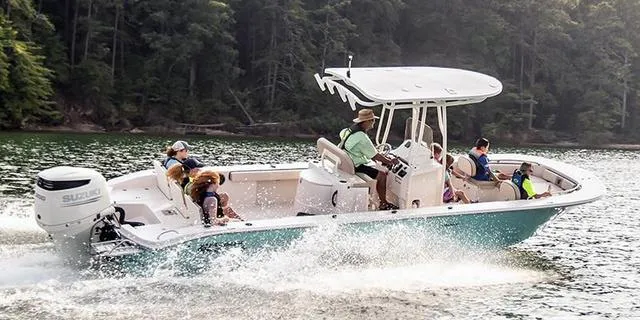 Slide: The Image of 2025 Carolina Skiff 26 Ultra Elite cruising on a lake with passengers enjoying the ride. - 1