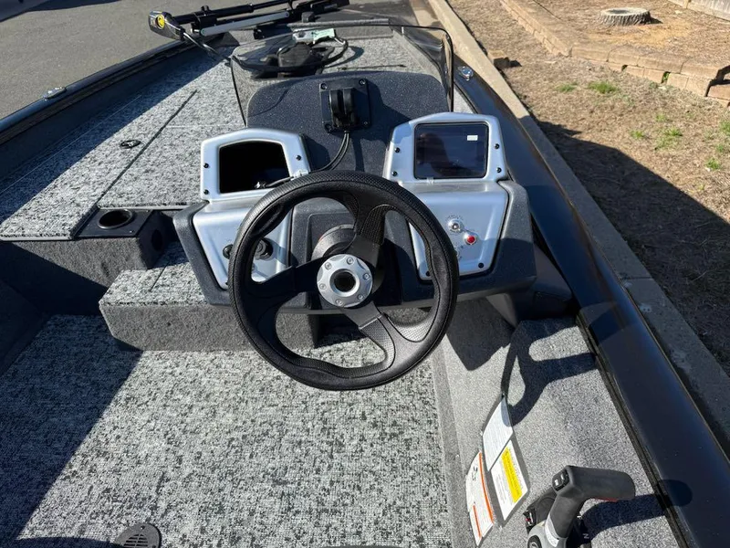 Slide: The Image of 2025 Tracker Pro Team 175 boat dashboard with steering wheel and control panel. - 6