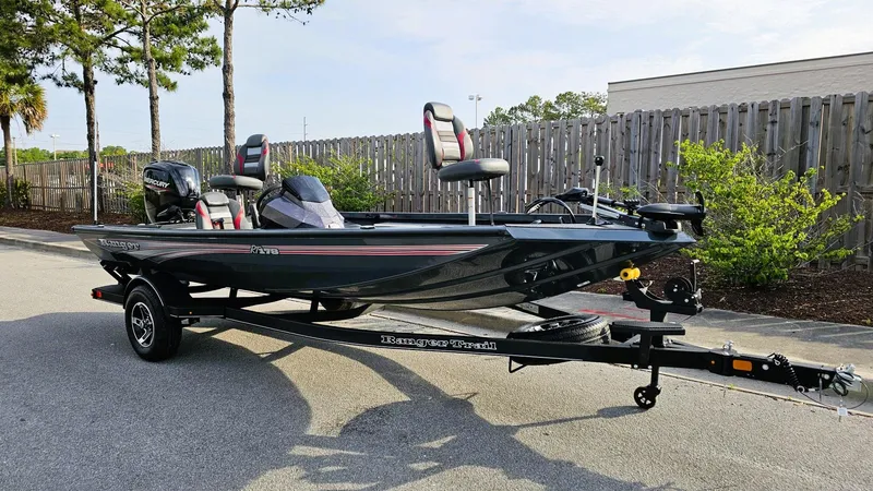 Slide: The Image of 2025 Ranger RT178 boat on trailer, parked outdoors, featuring sleek design and modern seating. - 4