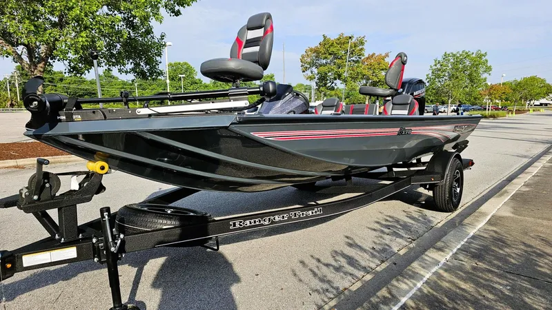 Slide: The Image of 2025 Ranger RT178 boat on trailer, parked outdoors, featuring sleek design and modern seating. - 7