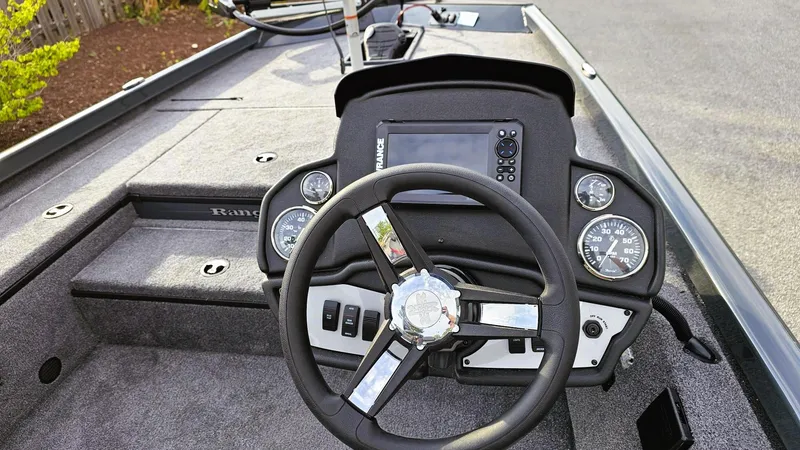 Slide: The Image of 2025 Ranger RT178 boat dashboard with steering wheel and control panel. - 9