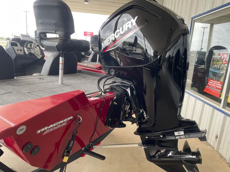 Slide: The Image of 2025 Tracker Pro Team 175 boat with Mercury outboard motor, displayed in a showroom. - 3