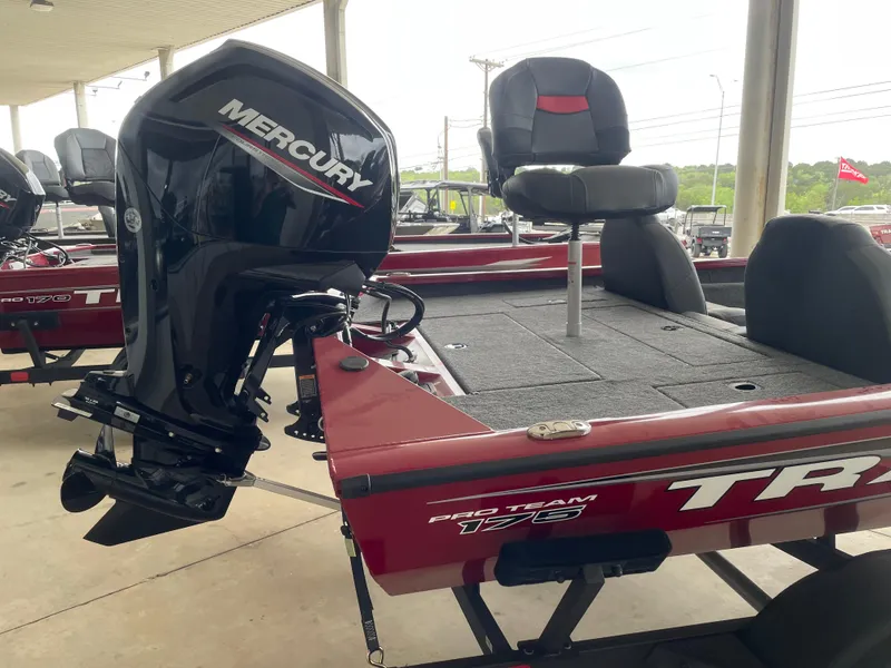 Slide: The Image of 2025 Tracker Pro Team 175 boat with Mercury engine, red exterior, and seating. - 4