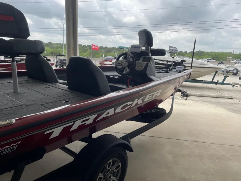 Slide: The Image of 2025 Tracker Pro Team 175 boat on trailer, parked outdoors under cloudy sky. - 5