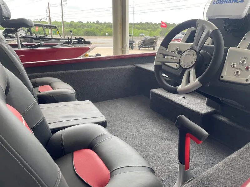 Slide: The Image of 2025 Tracker Pro Team 175 boat interior with steering wheel and seats. - 9