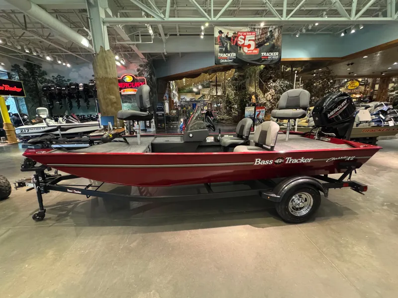 Slide: The Image of 2025 Tracker Bass Tracker Classic XL boat displayed in a showroom. - 2