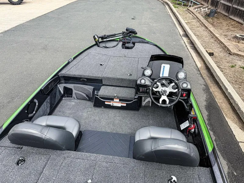 Slide: The Image of 2025 Nitro Z17 boat interior with dual seats and steering console on a paved road. - 6