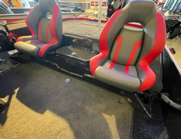 Slide: The Image of 2025 Nitro Z19 boat interior with red and gray seats, carpeted flooring. - 3