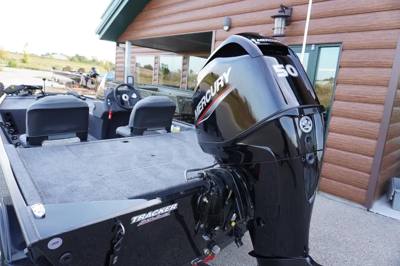 Slide: The Image of 2025 Tracker Bass Tracker Classic XL boat with Mercury 50 engine, parked near a building. - 63