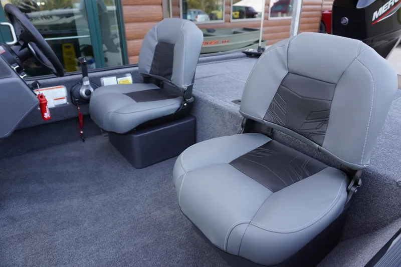 Slide: The Image of 2025 Tracker Bass Tracker Classic XL boat interior with gray seating and steering console. - 65