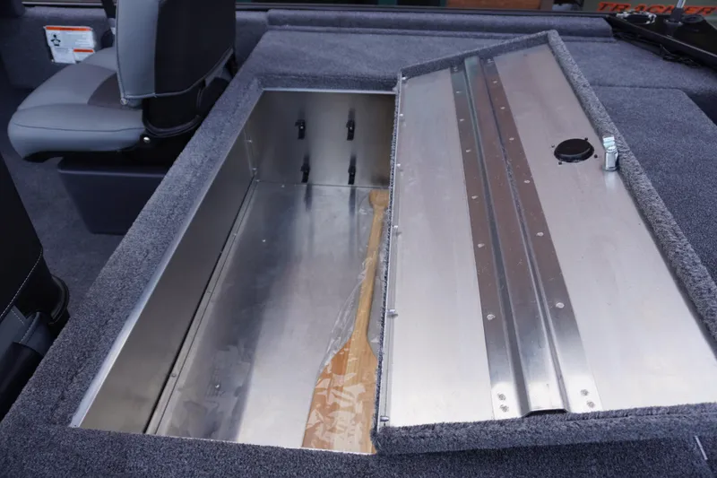 Slide: The Image of 2025 Tracker Bass Tracker Classic XL boat storage compartment with open lid, showcasing interior space. - 67