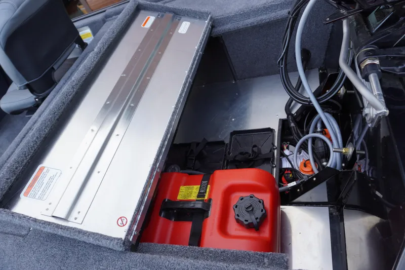 Slide: The Image of 2025 Tracker Bass Tracker Classic XL boat interior showing storage and fuel tank. - 68