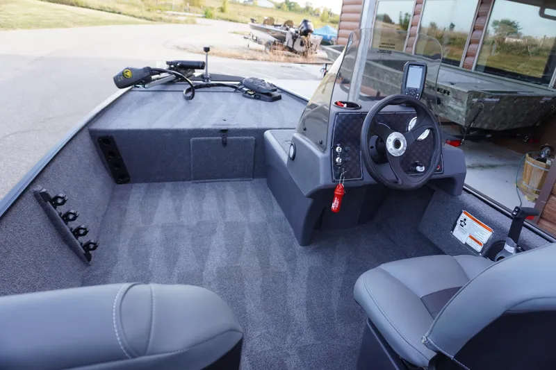 Slide: The Image of 2025 Tracker Bass Tracker Classic XL boat interior with steering wheel and seating. - 70