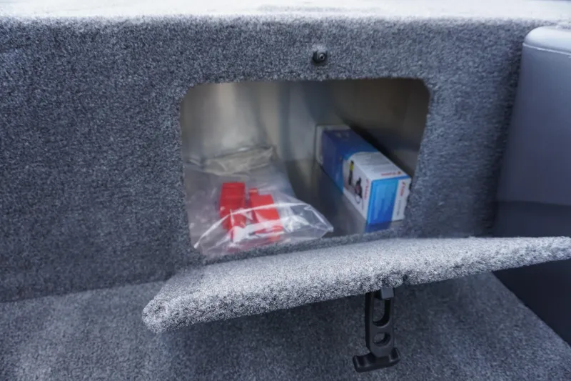 Slide: The Image of Storage compartment in 2025 Tracker Bass Tracker Classic XL boat, featuring carpeted interior. - 71