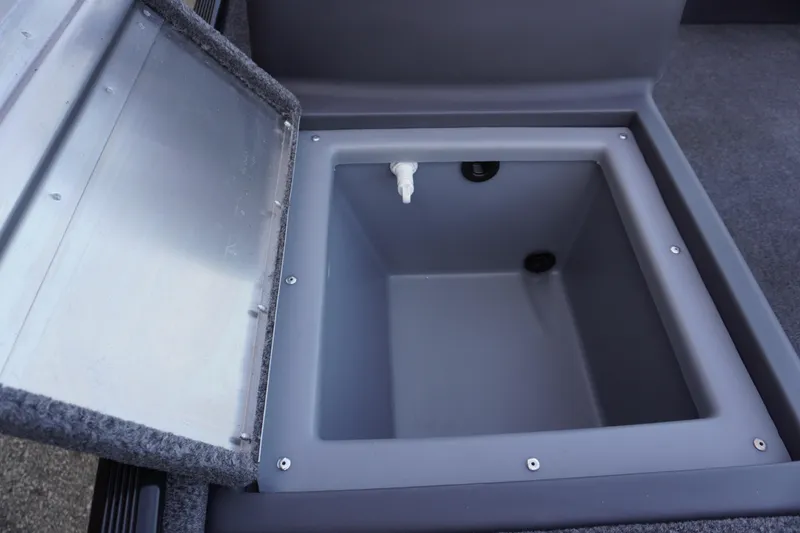Slide: The Image of 2025 Tracker Bass Tracker Classic XL livewell compartment, open lid, gray interior. - 72