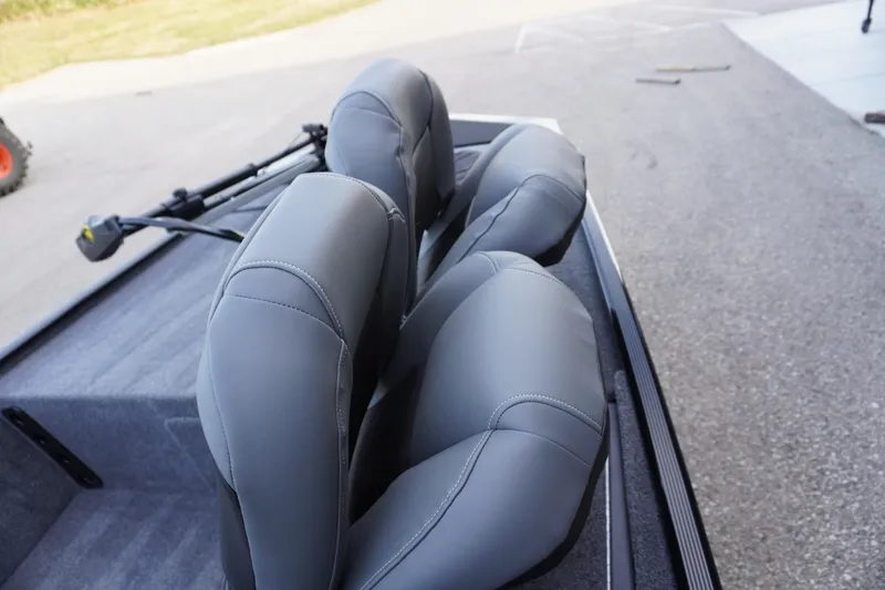 Slide: The Image of 2025 Tracker Bass Tracker Classic XL boat seats, gray upholstery, outdoor setting. - 74